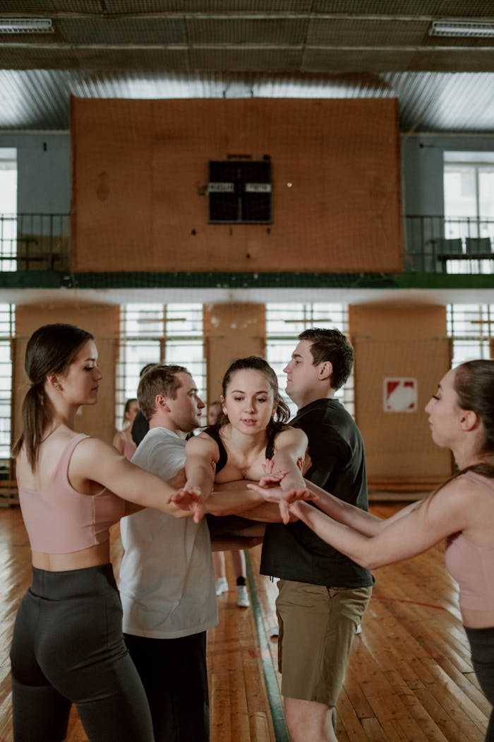 Group practicing teamwork and balance during an indoor training session.